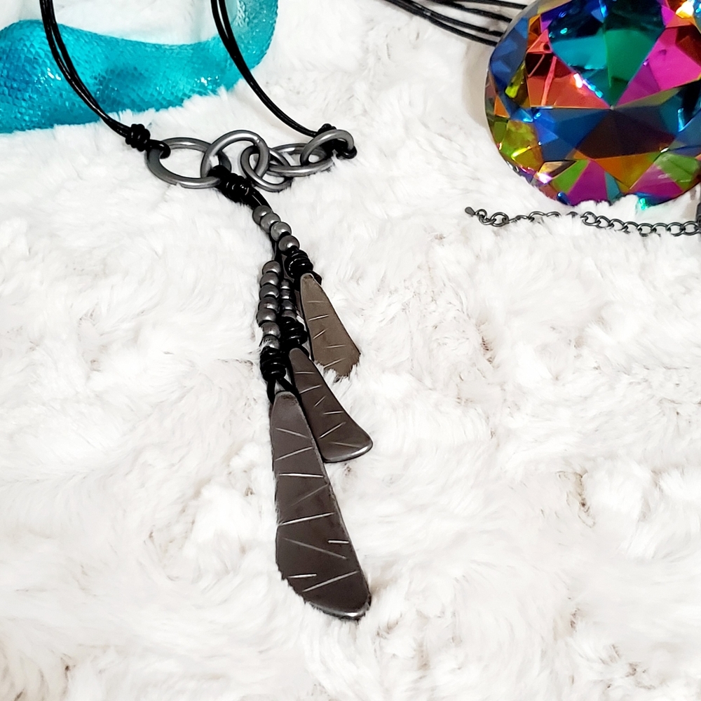Abstract Graphics muted silvertone metal on a black cord necklace